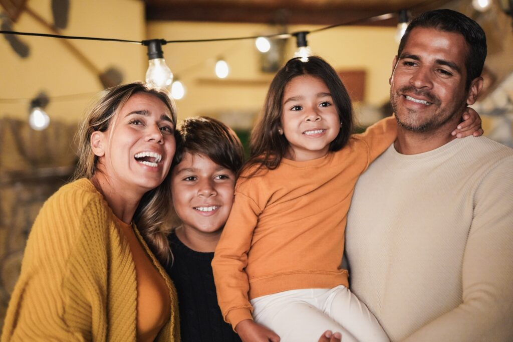 Happy latin family portrait at home on patio